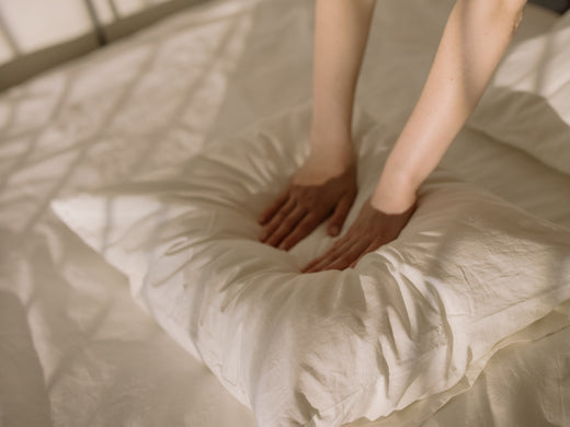 a person pressing pillow with two hands