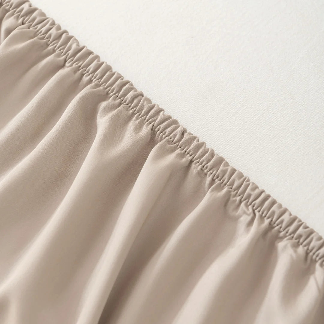 Close-up of neatly sewn elastic gathering on Linenly's Bamboo Fitted Sheet - Taupe.
