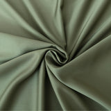 An elegant swirl pattern created from a luxurious sage green fabric with a satin weave, highlighting the graceful folds and soft shadows is captured in the Linenly Bamboo Pillowcase Set in Moss.