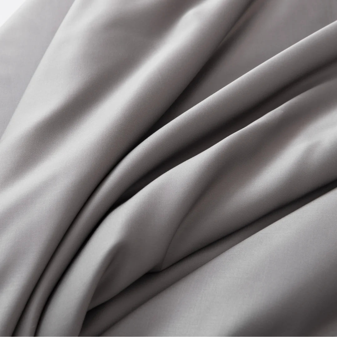 Elegant folds of Linenly's Bamboo Pillowcase Set in Stone Grey, made with smooth, soft grey fabric and a luxurious satin weave texture.