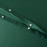 Close-up of green fabric from the Bamboo Quilt Cover Set - Evergreen by Linenly, showcasing two visible layers with rows of white buttons. The silky texture looks smooth and shiny, suggesting a luxurious satin-like finish.