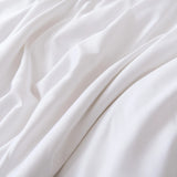 The Linenly Bamboo Pillowcase Set in White features soft, organic bamboo fabric with a smooth texture and gentle folds, offering a calming sense of comfort.
